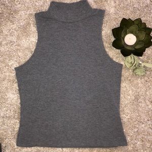 Gray Turtle neck with no sleeves.
